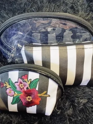 pack of three white cosmetic bags with stripes, flowers, transparent
